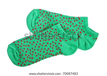 Pair of funny green female socks with red peas on white background