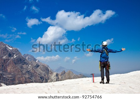 Climber on top of snow summit