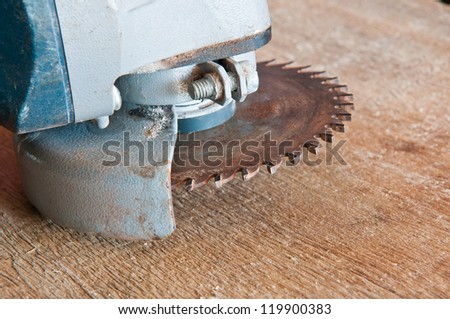 old circular saw blade on wood background
