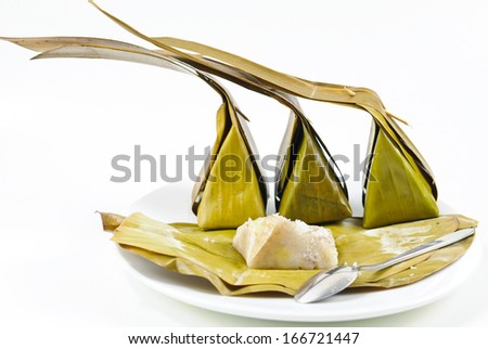thai dessert made from coconut banana flour sugar and wrapped in banana leaves