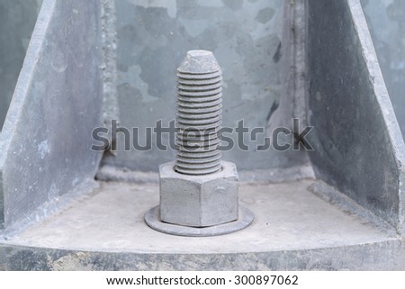 larger nut into the base of a metal pillar