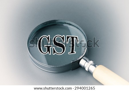 Goods and Services Tax (GST) alphabet with Magnifying Glass