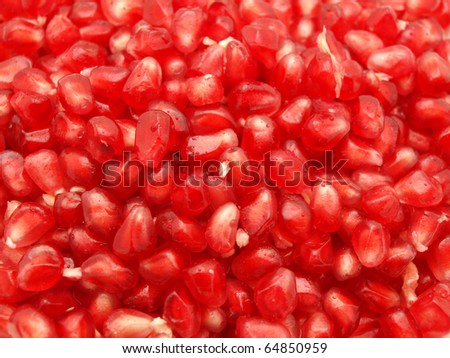 Red grains of a pomegranate. A background