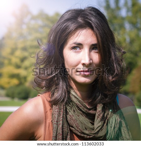 beautiful girl with scarf on the lawn in autumn