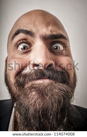 elegant bearded man with jacket and funny expressions on white background