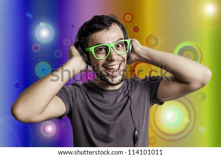 Crazy guy with headphones and green glasses on colorful background