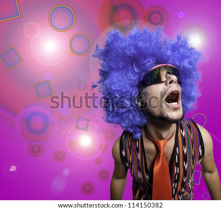 crazy guy with sunglasses and blue wig on colorful background
