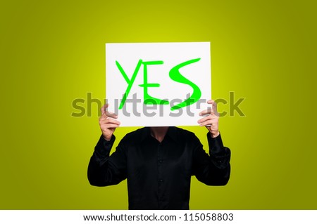 optimist person with sign and black shirt on yellow background