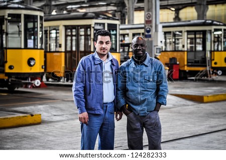 MILAN, ITALY - APRIL 19: workers of ATM magazine in Milan April 19, 2010. One time a year people can visit magazine garage of public transport company of Milan where there are old and new vehicles