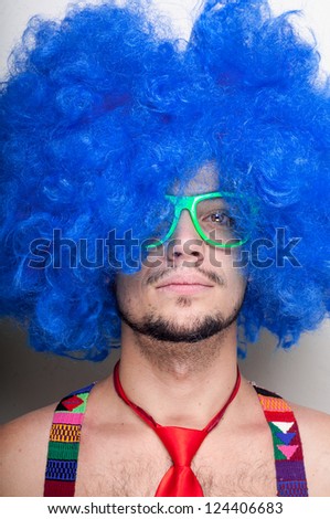 Funny guy naked with blue wig and red tie on white background