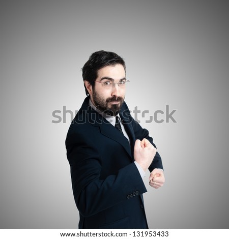 strong business man flexing muscle on gray background