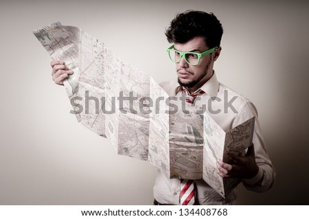 lost businessman with map on gray background