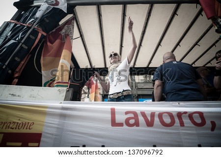 MILAN, ITALY - MAY 1: labor day held in Milan on May 1, 2013. Every year thousands of people taking to the streets to celebrate labor day and to protest against italian austerity