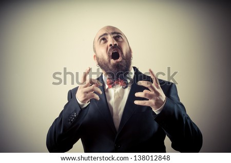 funny afraid elegant bearded man on vignetting background