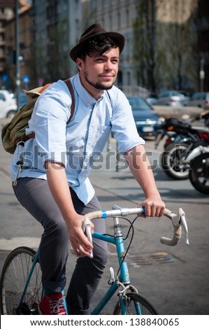 hipster young man on bike in the city