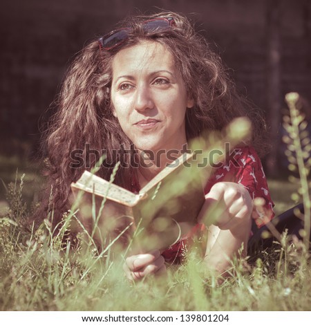 eastern hipster vintage woman reading book in the park
