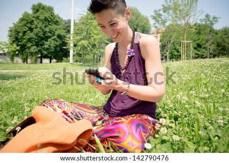 beautiful hipster short hair woman in the park in the city