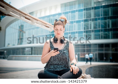 beautiful stylish modern young woman on the phone in the city