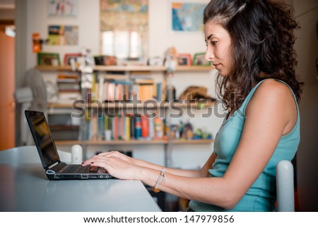 woman at home using notebook