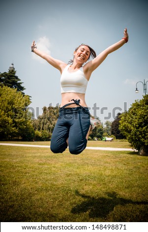 beautiful woman fitness jumping at the park