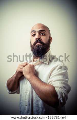 long beard and mustache man with white shirt on gray background
