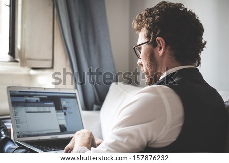 Elegant Attractive Fashion Hipster Man Using Notebook At Home