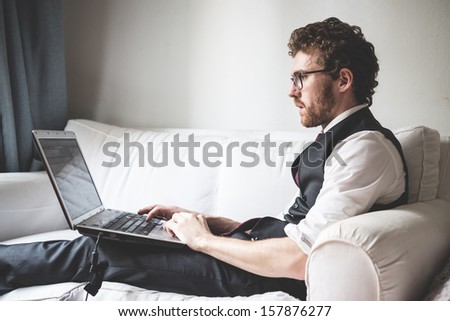 Elegant Attractive Fashion Hipster Man Using Notebook At Home