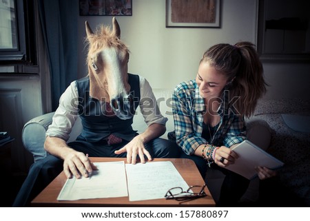 horse mask man and woman working at home