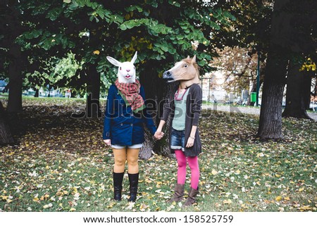 horse and rabbit mask women in the park autumn