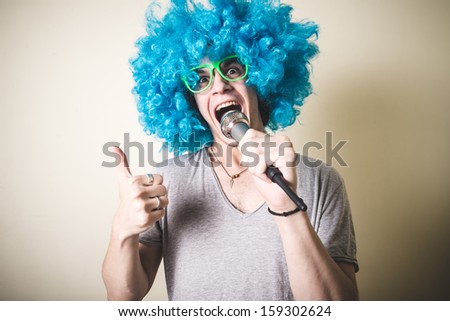 funny guy with blue wig singing on white background