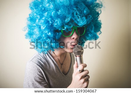 funny guy with blue wig singing on white background