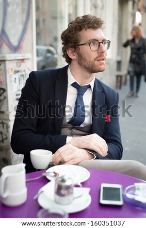 elegant attractive fashion hipster man lifestyle at the bar