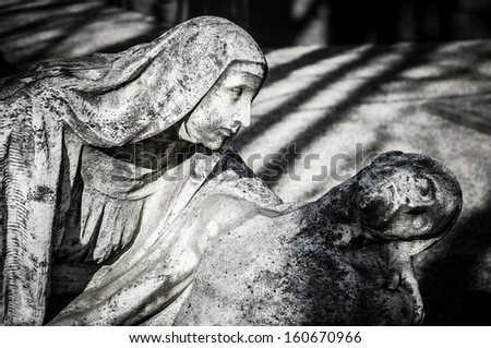 jesus christ and virgin mary statue in the cemetery