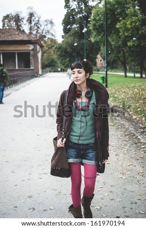 beautiful young woman walking in the park autumn
