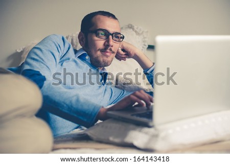 elegant business multitasking multimedia man using devices at home