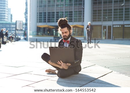 Stylish elegant dreadlocks businessman using notebook in business landscape