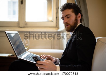 Handsome Bearded Hipster Elegant Man Using Laptop