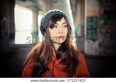 beautiful woman red coat winter listening music headphones park