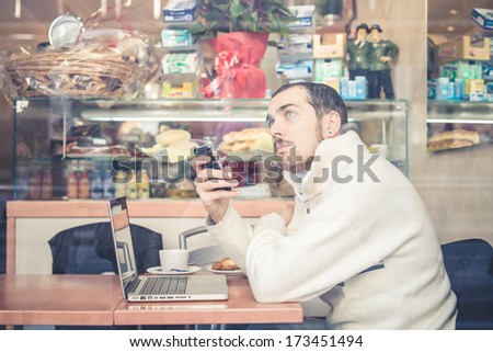 multitasking man using tablet, laptop and cellphone connecting wifi