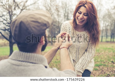 couple in love marriage proposal at the park winter