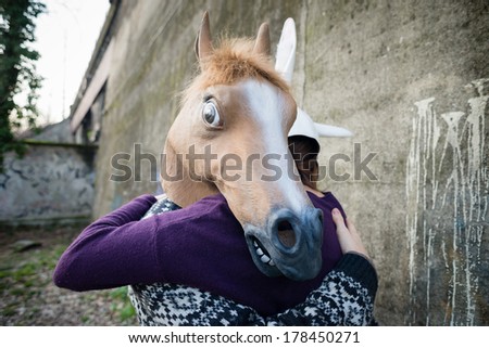 young hipster couple lovers rabbit and horse mask at the park