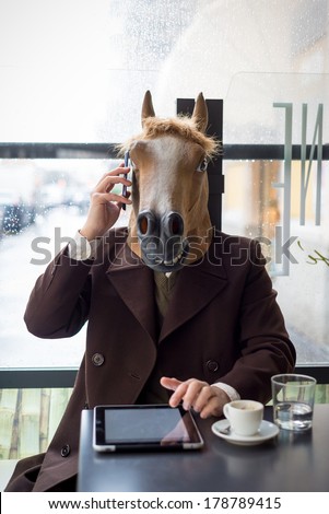 young stylish man lifestyle horse mask at the bar in the city