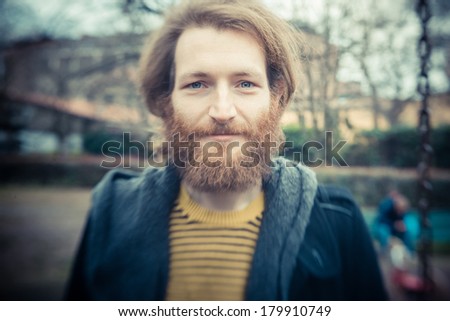 young handsome bearded hipster man outdoors
