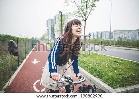 beautiful woman biker cycling in a desolate urban landscape