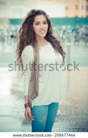 beautiful curly long brunette hair moroccan woman in the city