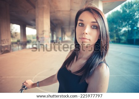 young beautiful brunette straight hair woman using bike outdoor