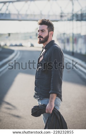 young handsome attractive bearded model man in urban context