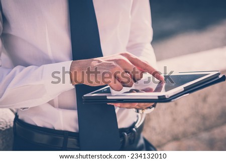 close up businessman man hand using tablet device outdoor