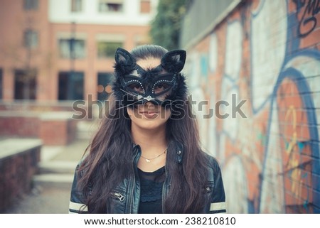 cat mask young beautiful brunette woman in the city