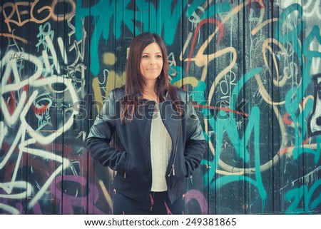 young beautiful brunette straight hair woman in the park during autumn season